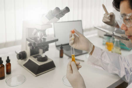 Scientist holding a test tube containing cannabis extract
