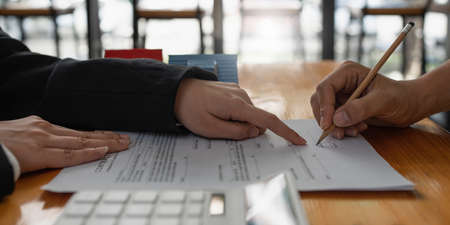 Business woman or Real Estate agent explain signing agreement for buying house. Bank manager and...
