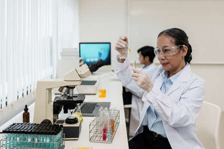 Scientist holding a test tube containing cannabis extractの写真素材