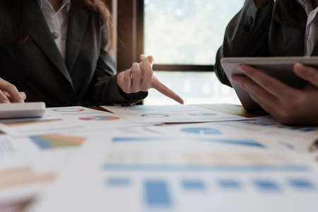 Account, audit and saving concept. Business Woman do math and analyze with calculator