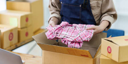 Attractive Asian SME business woman checking order at warehouseの写真素材