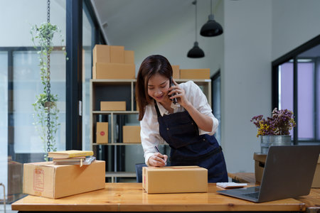 Attractive Asian entrepreneur business woman checking orderの写真素材