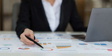 Businesswoman analyzes companys financial system and using calculatorの写真素材