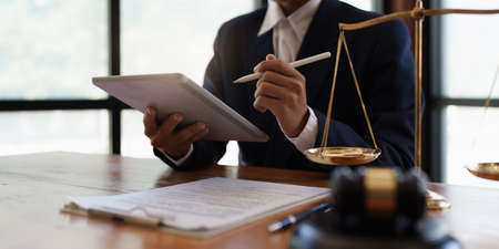 Lawyer working or reading agreement contract in office workplace for consultant lawyer concept