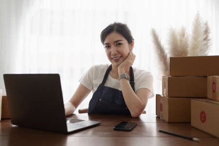 Attractive Asian SME business woman working at home office. online shopping conceptの写真素材