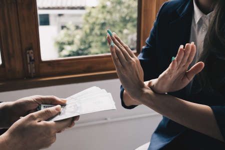 Lawyer Rejecting offer of black money in exchange for a permit in the deal. Concepts of corruption and anti briberyの写真素材