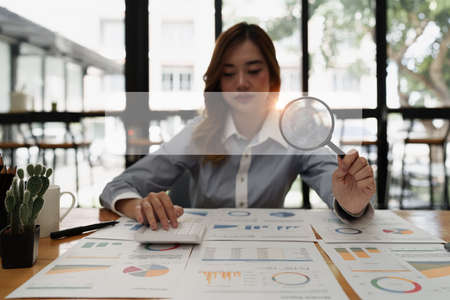 Modern business woman audit and searching on finance paperwork document of companyの写真素材