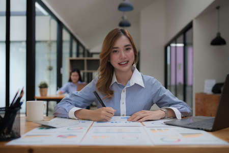 Modern business woman analysis financial paperwork documentの写真素材