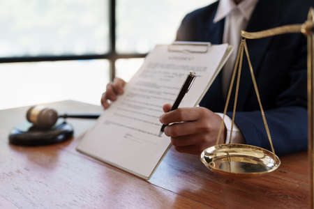 Lawyer working or reading agreement contract in office workplace for consultant. lawyer concept