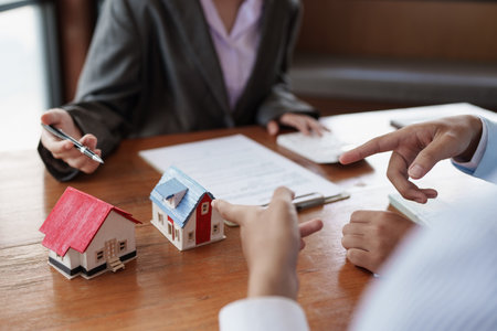 Young couple to decide before buying and sign in agreement contract. Real Estate conceptの写真素材