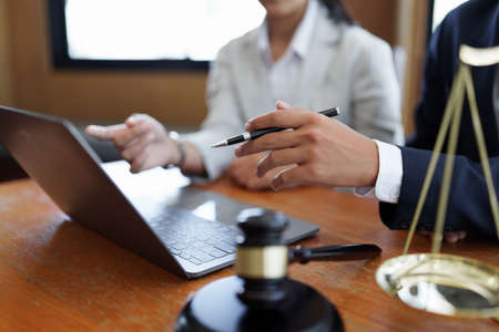 Business woman and lawyers discussing real estate agreement contractの写真素材