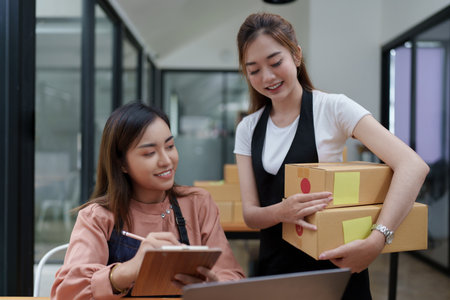 Asian SME business woman with partner working at home office. online shopping conceptの写真素材
