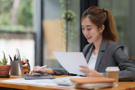 Modern business woman analysis financial paperwork documentの写真素材