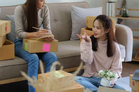 Asian SME business woman with partner working at home office. online shopping conceptの写真素材