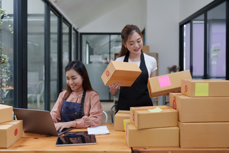 Two Asian SME business woman working at home office. online shopping conceptの写真素材