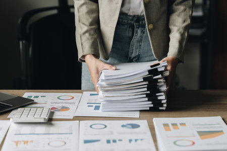 Businesswoman with many financial document to audit budget of company. tax, bill, account conceptの写真素材