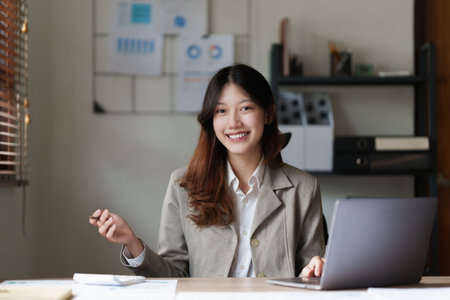 Businesswoman calculating bills, taxes and saving account balance. Finance conceptの写真素材