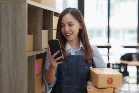 Asian small business owner working at home office. Business retail market and online sell marketing delivery, SME e-commerce conceptの写真素材