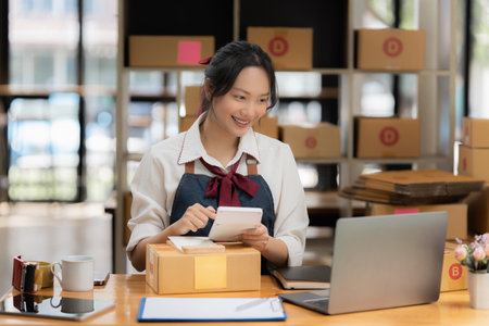 Asian small business owner working at home office. Business retail market and online sell marketing delivery, SME e-commerce conceptの写真素材