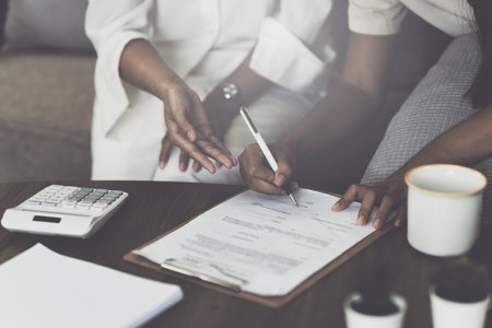 Real Estate Agent explain insurance and agreement contract to client before sign contractの写真素材