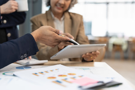 Fund managers team consultation and discuss about analysis Investment stock market by digital tabletの写真素材