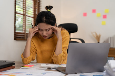 Portrait of stressed asian businesswoman in the office. burnout syndrome or deadline project concept