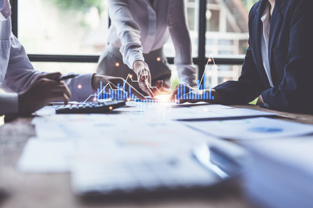 Group of business people working with financial infographics at meeting roomの写真素材