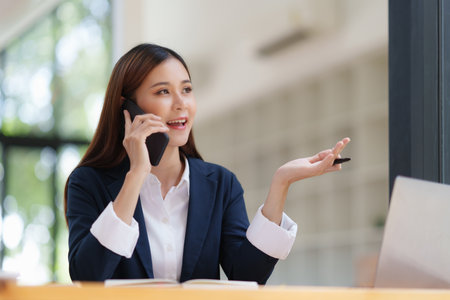Asian Business woman making business call talking on phone. Account and Finance conceptの写真素材