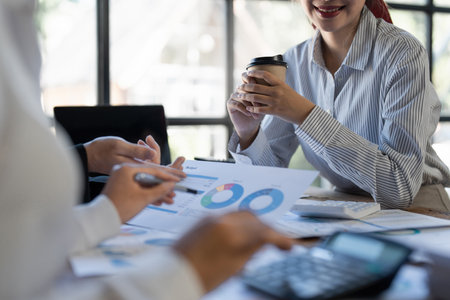 Asian Businessman working to analyze technical price graph and indicator with business teamの写真素材