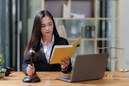 Lawyer business woman working or reading lawbook in office workplace for consultant lawyer conceptの写真素材