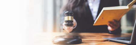 Close up lawyer working or reading lawbook in office workplace for consultant lawyer conceptの写真素材