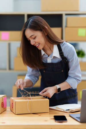 Asian small business owner working at home office. Business retail market and online sell marketing delivery, SME e-commerce conceptの写真素材