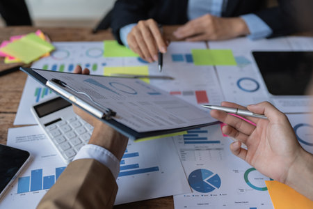 Fund managers team consultation and discuss about analysis Investment stock market by digital tabletの写真素材