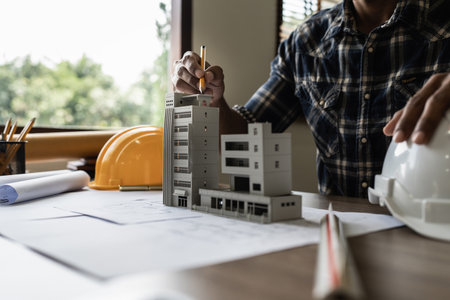 Architect man working with blueprints for architectural plan, engineer sketching a construction...