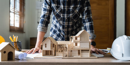 Architect man working with blueprints for architectural plan, engineer sketching a construction...