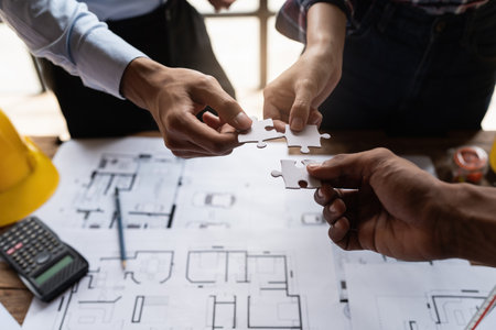 Architect team working with blueprints for architectural plan, engineer sketching a construction...
