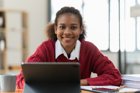 Portrait of beautiful young black woman using digital tablet.の写真素材