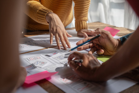 Group of ux developer and ui designer brainstorming about app interface design at modern office. Creative digital development agencyの写真素材