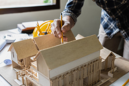 Architect man working with blueprints for architectural plan, engineer sketching a construction...