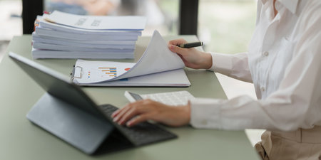 Pleasant positive business woman using digital tablet at home office