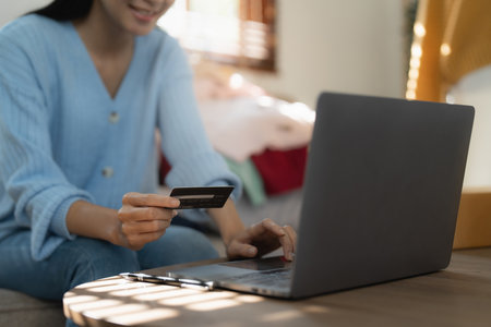 Young person using credit card and laptop computer. Online shopping, e-commerce conceptの写真素材