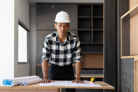 Architect man working with blueprints for architectural plan, engineer sketching a construction...