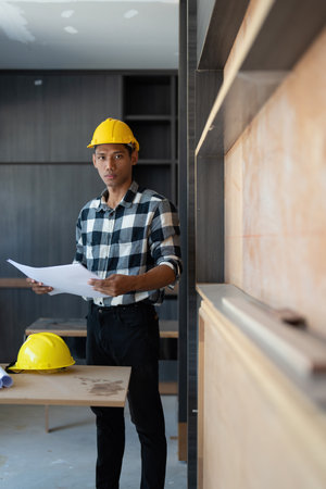 Architect man working with blueprints for architectural plan, engineer sketching a construction...