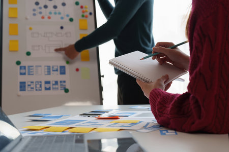 Group of ux developer and ui designer brainstorming about app interface design at modern office. Creative digital development agencyの写真素材
