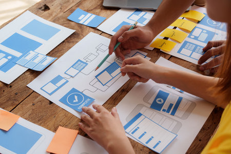 Group of ux developer and ui designer brainstorming about app interface design at modern office....
