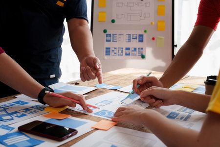 Group of ux developer and ui designer brainstorming about app interface design at modern office. Creative digital development agencyの写真素材