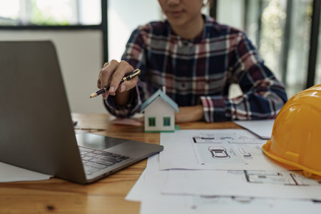 Professional architect designer structural engineer working with blueprint design project.の写真素材