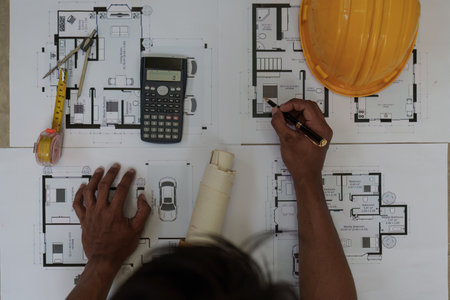 Professional architect designer structural engineer working with blueprint design projectの写真素材