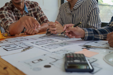 Professional architect designer structural engineer team colleagues discussing building plan design projectの写真素材