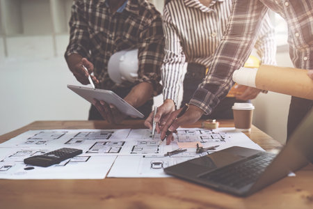 Professional architect designer structural engineer team colleagues discussing building plan design...